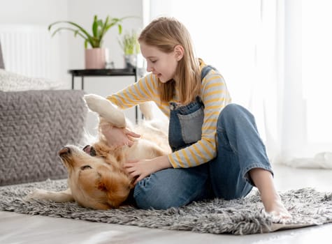 Girl Plays With Golden Retriever On Room Floor In Dog Game