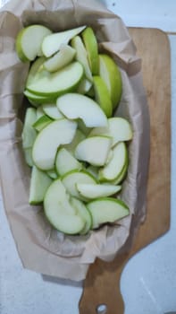 fresh green apples cut into slices for pie in a bowl. High quality photo