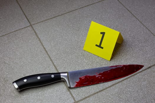 Bloody knife at crime scene next to evidence ID, bloody crime scene with bladed weapon