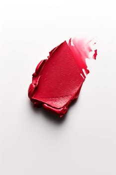 A smear of red lipstick on a white background. Decorative cosmetics. AI generated.