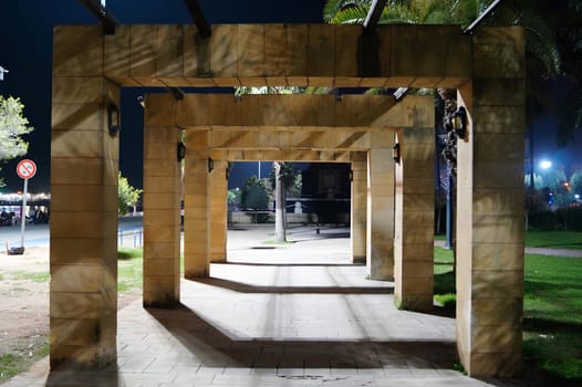 A long, empty walkway and lights