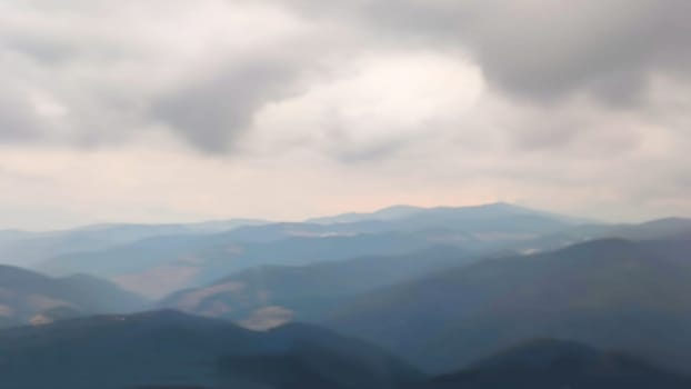 blurred mountain landscape and cloudy sky in a foggy haze, natural blue background.