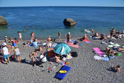 Foros, Crimea - June 30. 2019. Rocky beach with cliff in the Black Sea