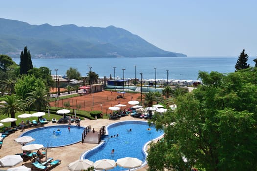 Becici, Montenegro - June 12.2019. View of pool hotel in popular resort village of Becici