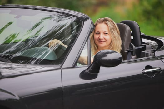 Attractive woman in a cabriolet in the Netherlands.