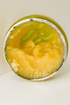 Orange body scrub with sugar and oil in glass jar copy space. Homemade cosmetic for peeling and spa care