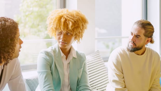 Multi-ethnic coworkers chatting during a coffee break in the office