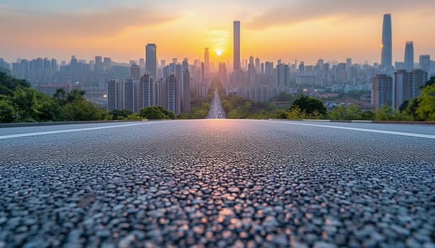 The perspective of the road against the background of sunset and the cityscape. High quality photo