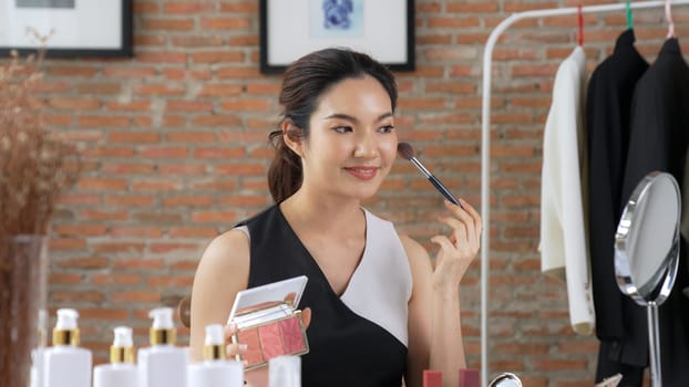 Woman influencer shoot live streaming vlog video review vivancy makeup social media or blog. Happy young girl with cosmetics studio lighting for marketing recording session broadcasting online.