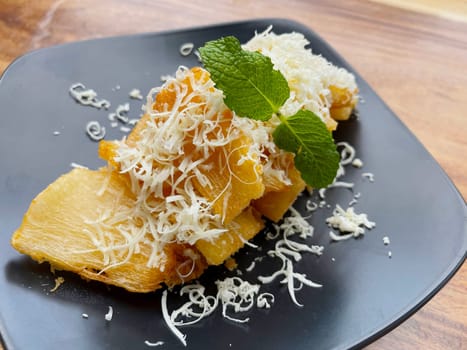 fried cassava with topping cheese on top, Indonesian traditional food, good for tea time or snack