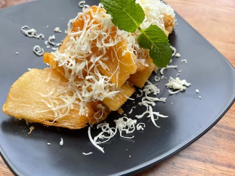 fried cassava with topping cheese on top, Indonesian traditional food, good for tea time or snack