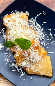 fried cassava with topping cheese on top, Indonesian traditional food, good for tea time or snack
