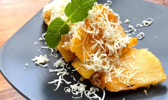 fried cassava with topping cheese on top, Indonesian traditional food, good for tea time or snack
