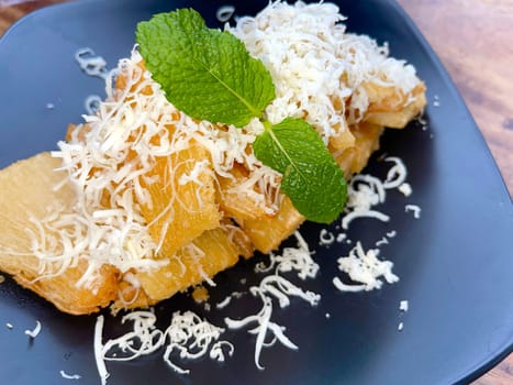 fried cassava with topping cheese on top, Indonesian traditional food, good for tea time or snack