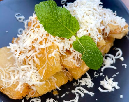 fried cassava with topping cheese on top, Indonesian traditional food, good for tea time or snack