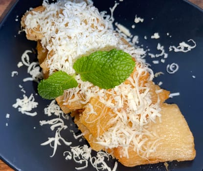 fried cassava with topping cheese on top, Indonesian traditional food, good for tea time or snack