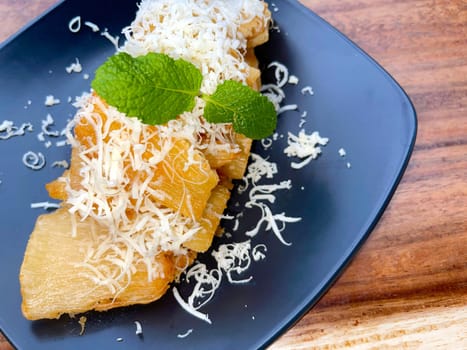 fried cassava with topping cheese on top, Indonesian traditional food, good for tea time or snack