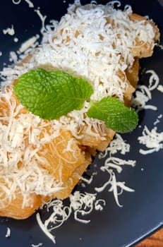 fried cassava with topping cheese on top, Indonesian traditional food, good for tea time or snack