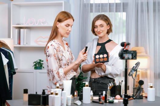 Woman influencer shoot live streaming vlog video review makeup utmost social media or blog. Happy young girl with cosmetics studio lighting for marketing recording session broadcasting online.