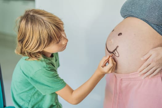 Adorable moment as a son adds a touch of joy to his mother's pregnancy, playfully drawing a funny face on her baby bump, creating cherished memories.