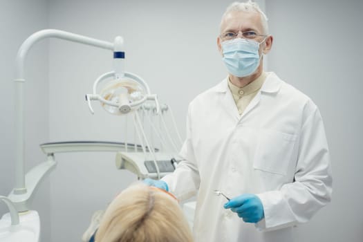 Woman smiling during her dental treatment at dentist.