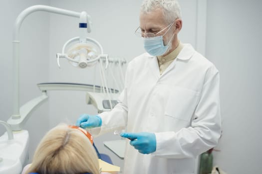 Woman smiling during her dental treatment at dentist.