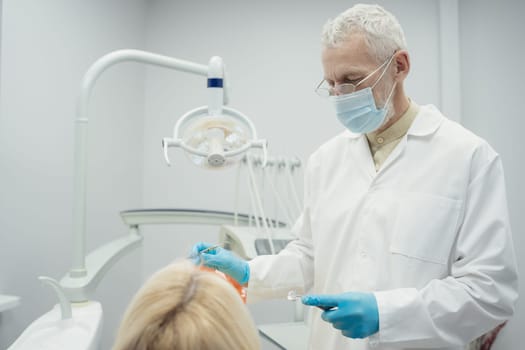 Woman smiling during her dental treatment at dentist.