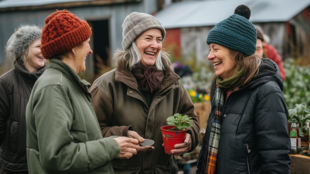 A group of women are talking and smiling while holding plants