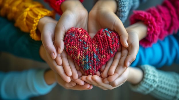 A group of people holding hands with a knitted heart in the middle