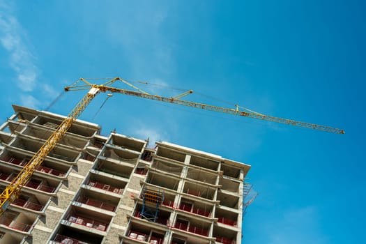 Construction crane working on large construction site