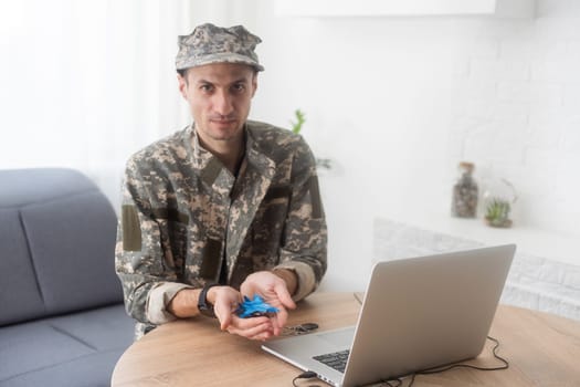 military man holding model fighter plane. High quality photo