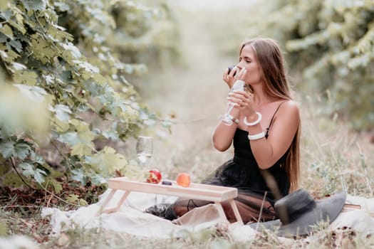 Picnic and wine tasting at sunset in the hills of Italy, Tuscany. Vineyards and open nature in the summer. Romantic dinner, fruit and wine.