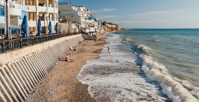 coastal area with apartment buildings of residential areas, modern hotel and restaurant complex on water and sandy beaches