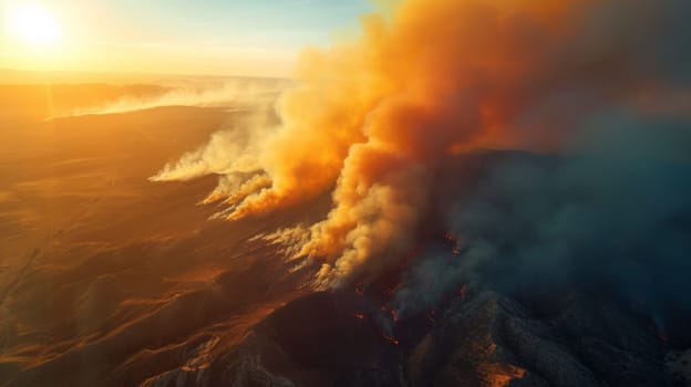 A large fire is burning on a mountain range with smoke billowing out