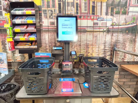Kirov, Russia - February 26, 2024: Self-Checkout Station at a Grocery Store. Two empty shopping baskets at self-service checkout kiosk