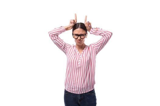 young cheerful slim business lady with a ponytail hairstyle wears glasses and a striped shirt on a white background.