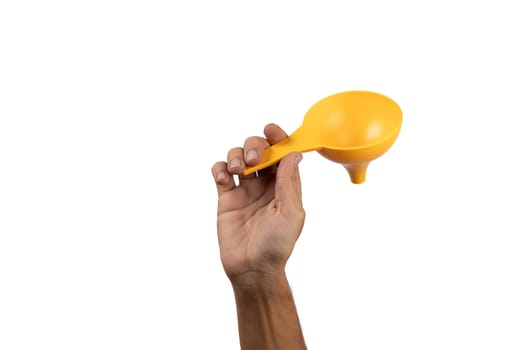 Black male hand holding a yellow kitchen funnel isolated, no background. High quality photo