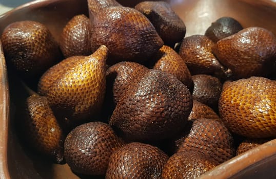 group of snake fruit or called salak in local indonesian language is a type of palm fruit commonly eaten also known as sala, the scientific name is Salacca zalacca.