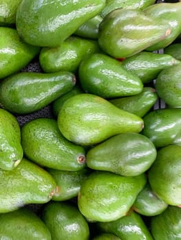 fresh produce of green avocados at the local market, healthy fresh fruit for salad or juice or guacamole