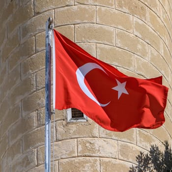 Turkish flag on the background of a brick wall of the mosque 1