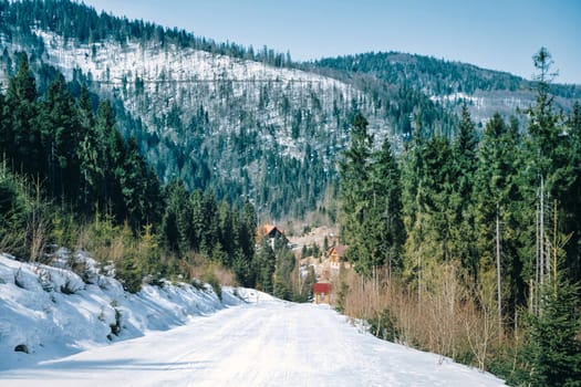 Snow road on the winter day. Slope on the skiing resort in Alps