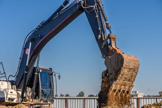 Close up details of industrial excavator working on construction site 1