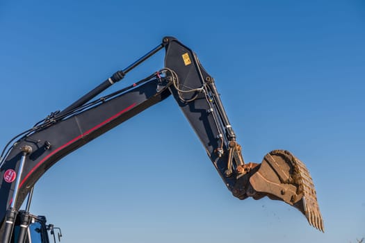 Close up details of industrial excavator working on construction site 4