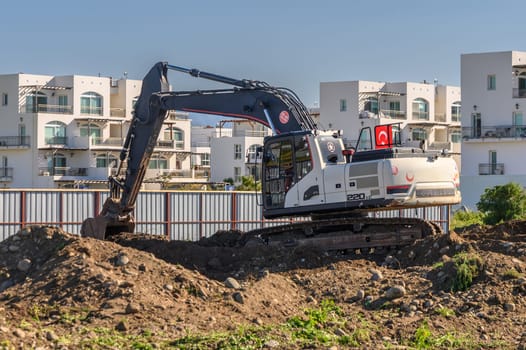 Excavator digging soil at a construction site 2