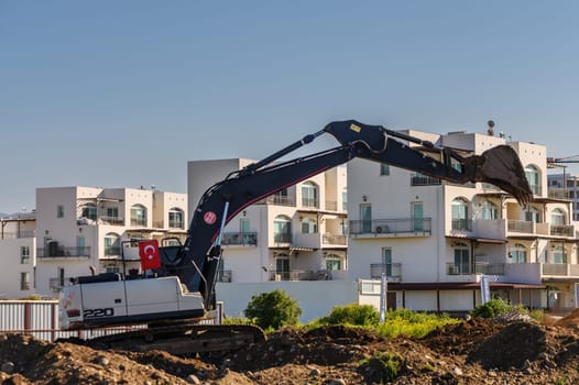 Excavator digging soil at a construction site 1