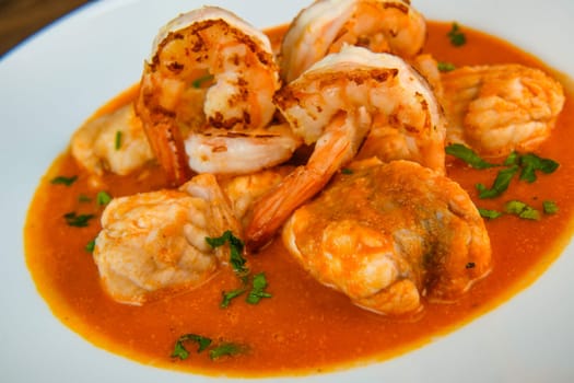 Recipe for Armorican-style monkfish tail, prawns, flambees with cognac, High quality photo