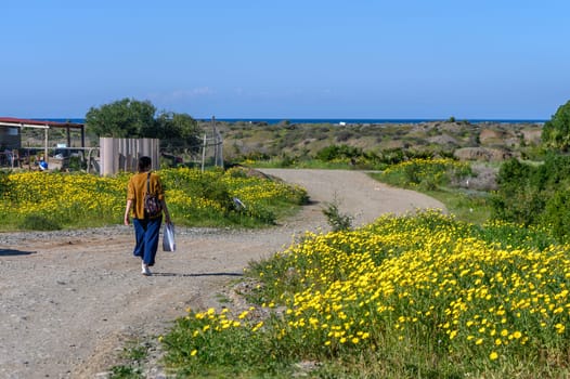 woman with a package walks through the village