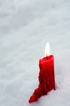 A symbol of memory. A single candle burns in the snow