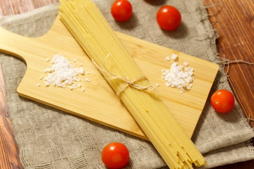 Italian raw spaghetti, close-up, macro. Italian cuisine or culinary concept. Selective focus