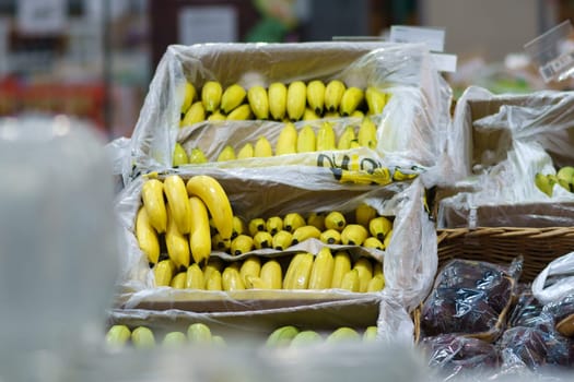 Bananas in the boxes in the supermarket. Healthy food. shopping concept